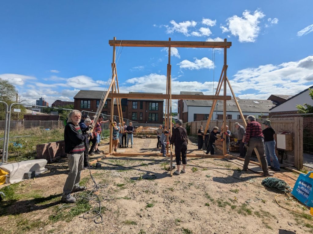 group of people holding up wooden frame