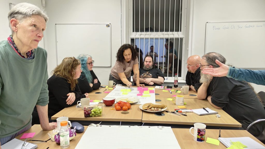 picture of a group of people working in a room talking